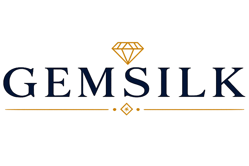 The logo for GEMSILK features the brand name in dark navy blue serif lettering, with a small gold diamond icon above and gold decorative lines below, all centered on a solid white background.