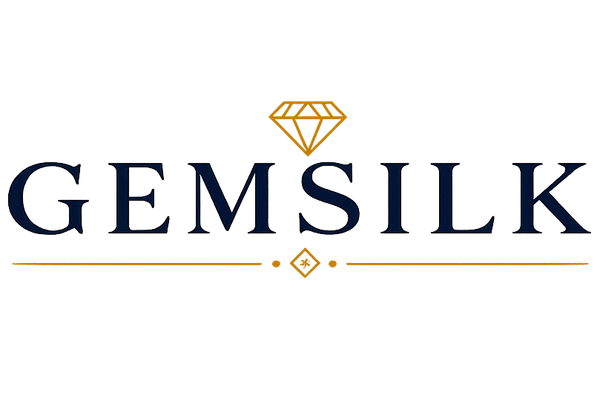 The logo for GEMSILK features the brand name in dark navy blue serif lettering, with a small gold diamond icon above and gold decorative lines below, all centered on a solid white background.